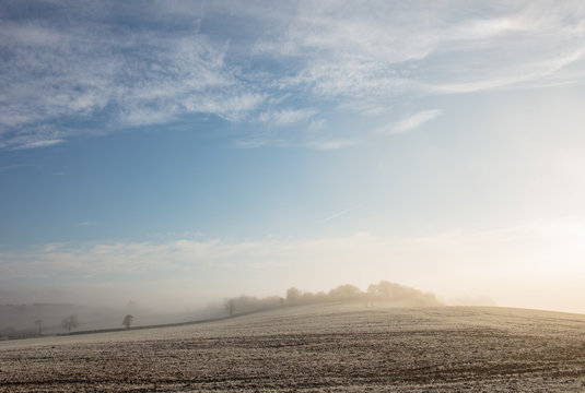 An open ploughed field on a sunny winter's morning.