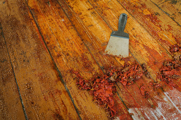 Old wooden floor and scraper tool with paint scraped - wooden floor renovation - obrazy, fototapety, plakaty