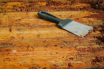Old wooden floor and scraper tool with paint scraped - wooden floor renovation - obrazy, fototapety, plakaty