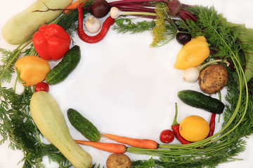 Summer vegetables on white background, top view, copy space. Pepper, dill, tomatoes, onions, beets, cucumbers, zucchini, ingredients for salad,