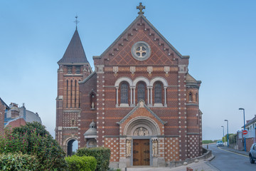Fototapeta na wymiar Mers-Les-Bains, France - 04 30 2019: Parish Church Mers at Sunrise