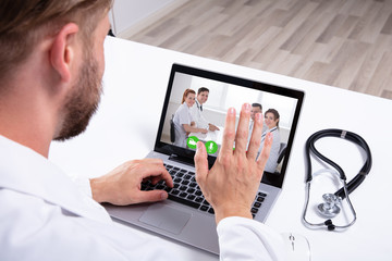 Doctor Having Video Conference On Laptop