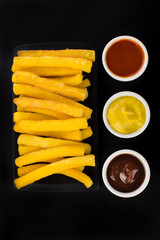 Traditional Brazilian recipe fried polenta in black background  seen from above