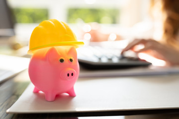 Close-up Of Piggybank With Hard Hat