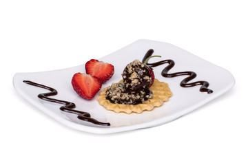 Strawberries on homemade wafer decorated with walnuts and chocolate