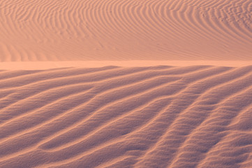 Sand texture background. Pink tint.