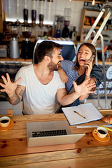 owners working with laptop ready to open their cafe..