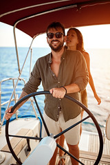 Romantic couple on the luxury boat enjoy at summer day.