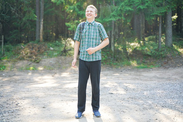 teenager boy lost alone in the countryside and scared in the forest