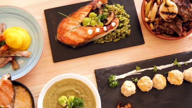 Dishes of traditional Norwegian cuisine with lamb rib, seafood and  vegetables served at plates