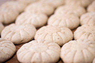 balls of dough bread getting ready to be baked
