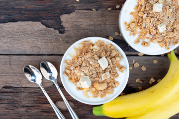 Yogurt and banana In white glass wood background from top view.