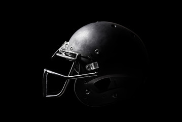 Football helmet on black background.