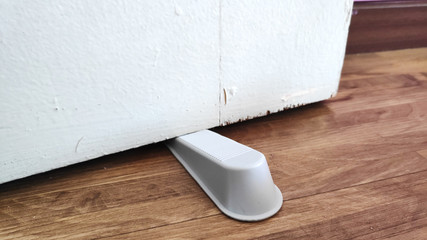 Door stopper to prevent wooden door from moving