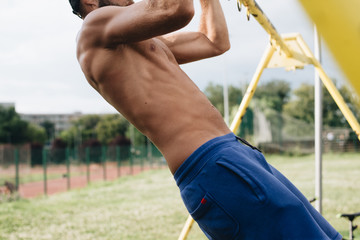 A muscular guy who works pull-ups, sport is life