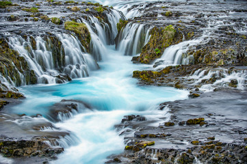 Fototapeta na wymiar Bruarfoss Waterfall is a beautiful waterfall in Iceland. Take a long time shot The water is frothy, soft and has a beautiful blue color.