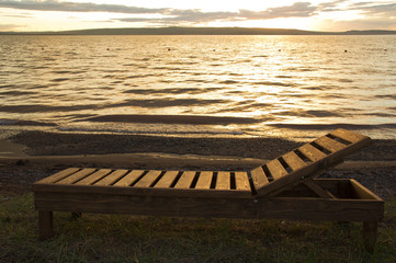 wooden deck chairs by the lake