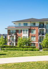 Brand new low rise apartment building on sunny day in British Columbia, Canada.