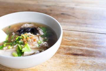 soup,Soup with pock, pock stick, mushroom, vegetable in white bowl on wood table. with copy space for text or design