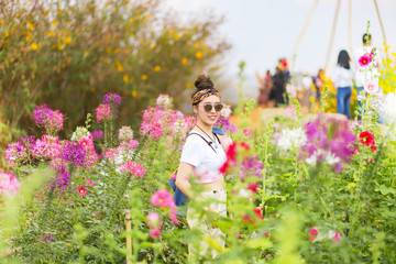 Asian female tourist in the flower field