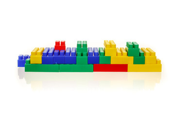 Abstract figure from a multi-colored children's plastic building kit on a white background