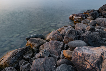 sunset at Franklin Beach Georgina Ontario Canada with nice trees, rocks, lake view, clouds, sun and wooden path