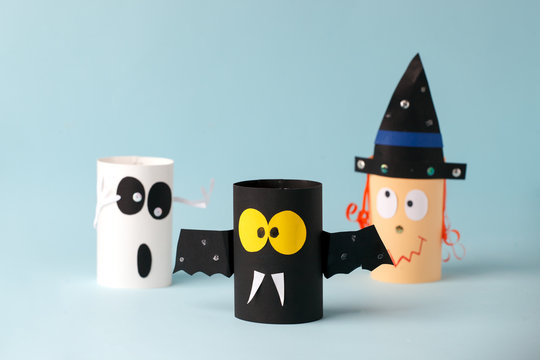 Halloween toy collection ghost, bat, witch on blue for Halloween concept background. Paper crafts, DIY. Handcraft creative idea fron toilet tube, recycle concept