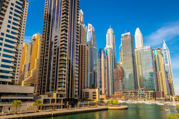 Obraz na płótnie Canvas High-rise houses of modern futuristic design of Dubai Marina district.