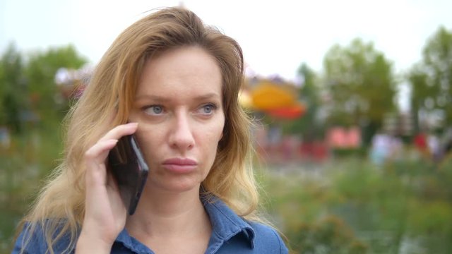 close-up. worried young woman talking on the phone. outdoor