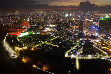 Fototapeta na wymiar Top View of Building in a City - Aerial view Skyscrapers flying by drone of Phnom Penh city with riverside , Palace and small island in sunset