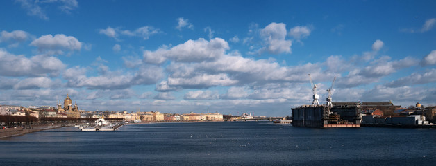 Panorama of the Neva from the side of the icebreaker Krasin. It is a ship-museum. On the other side there is a floating dock for repairing ships. Left - Assumption Cathedral