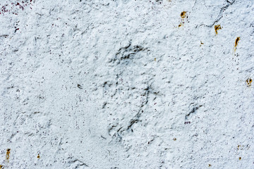 Texture of a concrete wall with cracks and scratches which can be used as a background