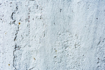 Texture of a concrete wall with cracks and scratches which can be used as a background
