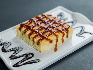 Tres leches dessert on plate over black table