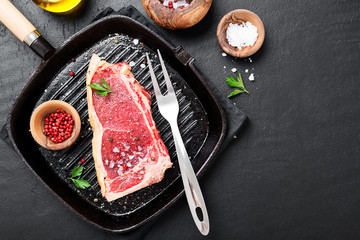 Fresh beef meat is ready for frying in a grill pan.