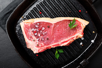Fresh beef meat is ready for frying in a grill pan.