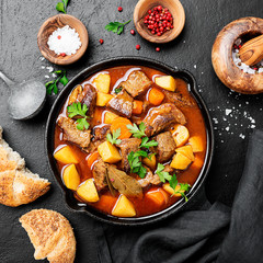 Beef meat  stewed with potatoes, carrots and spices (hungarian goulash).