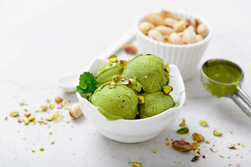 Pistachio ice cream with mint and chopped nuts.
