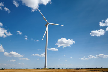 wind generator on bright cloudy sky background