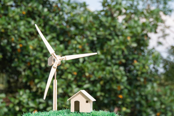 Power renewable energy future alternative /clean electric energy concept. Home / wind turbine on green grass that shows use of green energy. For alternative of nature or environmental conservation