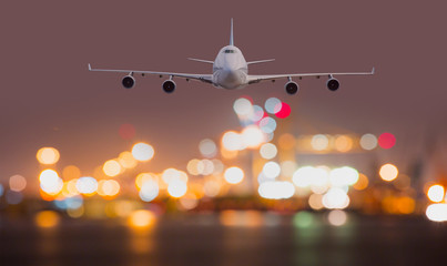 Airplane flies over the city of night with bokeh