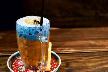 Thailand ice tea mixed with milk blue on a dark background.