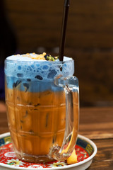 Thailand ice tea mixed with milk blue on a dark background.