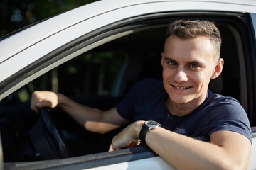 Happy young man with new car