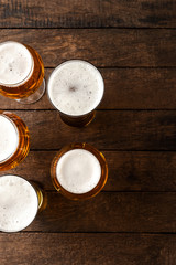 Beer glasses on wooden table.