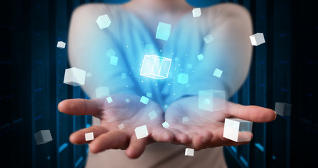 Person holding hologram projection displaying white cubes in server room