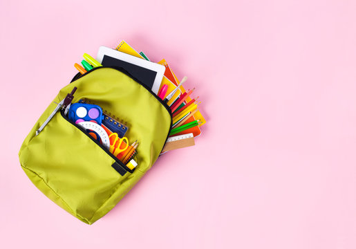 School backpack isolated on pink background.