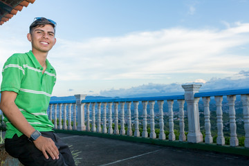 Young guy portrait outdoors with landscape at the background