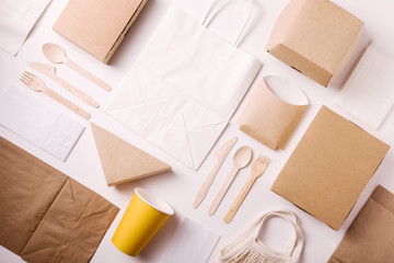 Top view and flat lay concept of Eco friendly, kraft, disposable, recyclable tableware. Paper food boxes, dishes on white background
