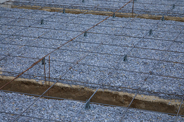 Plastic reinforcement fixers.  Iron wire mesh for concreting floors of buildings. Stacked Rebar...